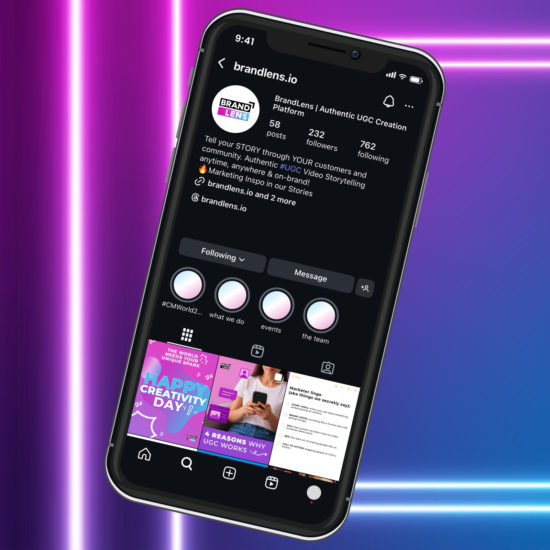 A smartphone on a neon background showing the Brand Lens profile page, which includes their bio and a grid of posts.